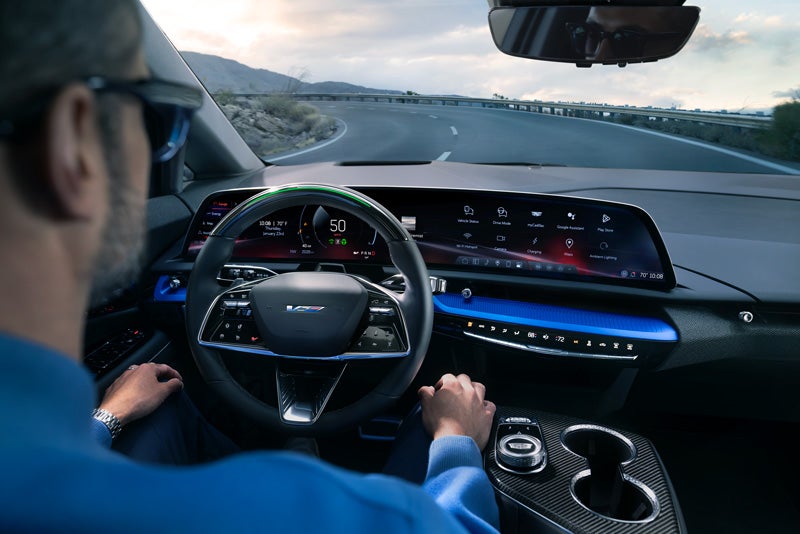 Front View of the 2026 OPTIQ-V Driving Through the Dusk Utilizing its Headlights | Joe Cooper Chevrolet in Shawnee OK